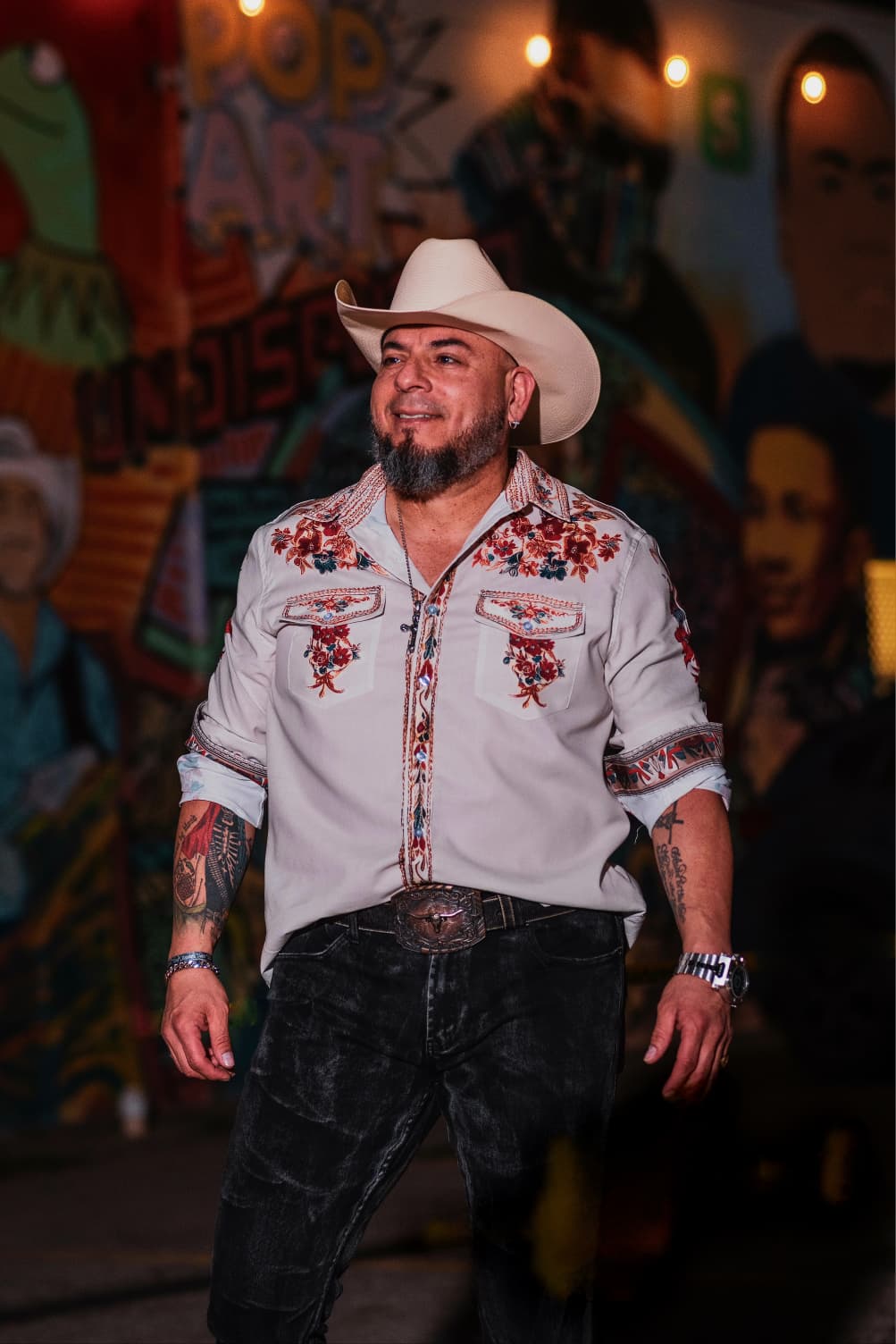 Domingo Elias 3Zero in front of a Tejano mural